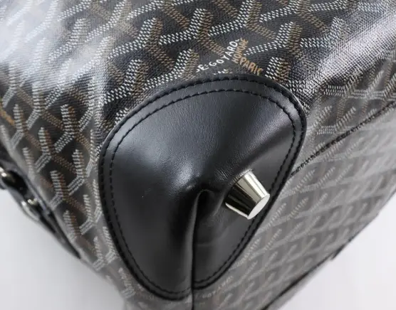 Goyard bag with leather corners and feet at the bottom