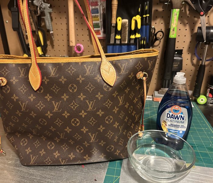 LV Neverfull with dove soap and a bowl a water about to get cleaned