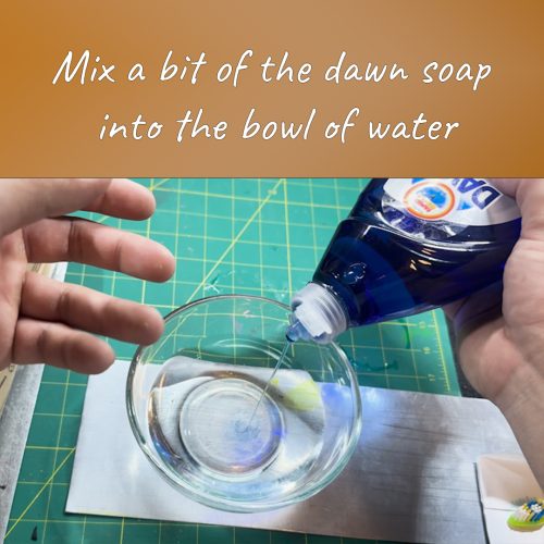 Mixing a bit of dawn soap into a bowl of water